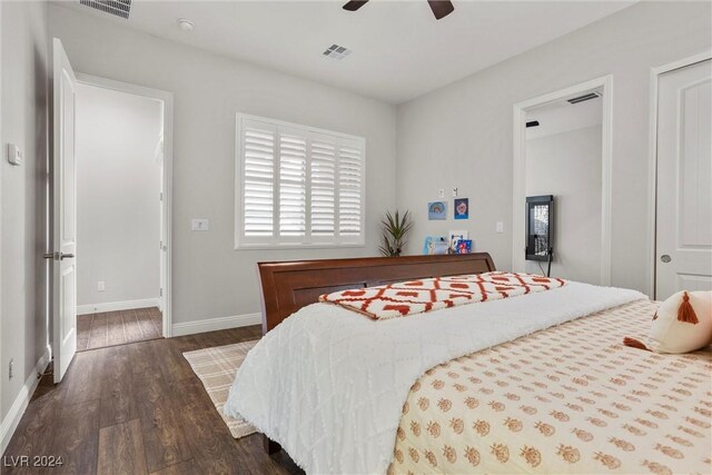 bedroom with dark hardwood / wood-style floors and ceiling fan