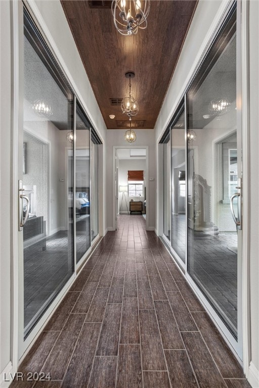 hallway with dark hardwood / wood-style floors and wooden ceiling