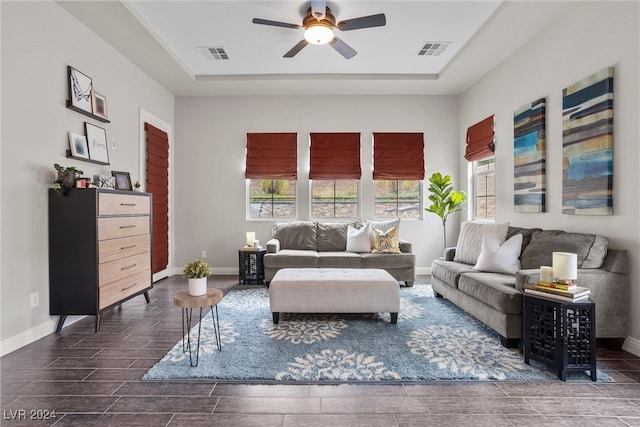 living room featuring dark hardwood / wood-style flooring and ceiling fan