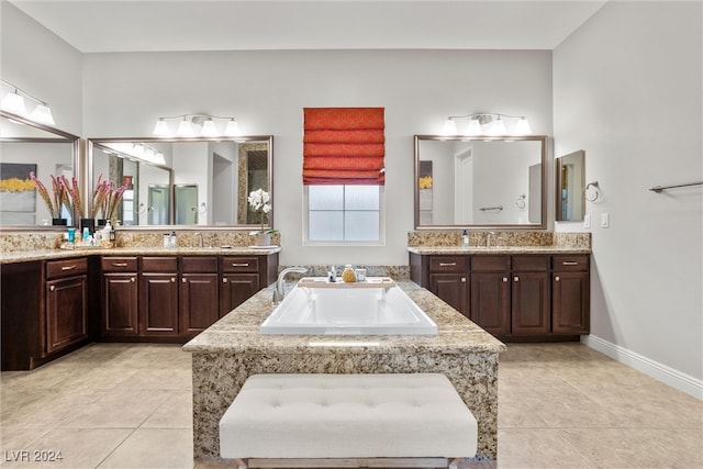 bathroom featuring vanity, tile patterned flooring, and a bathing tub