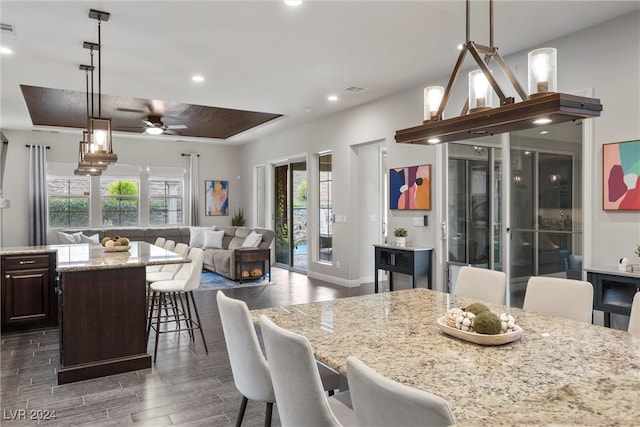 dining area with dark wood-type flooring, ceiling fan, and plenty of natural light