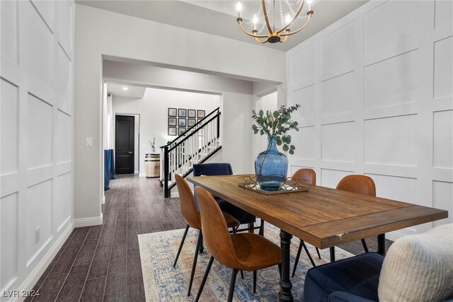 dining area with a chandelier and dark hardwood / wood-style flooring