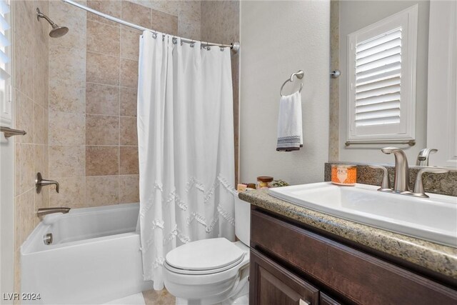 full bathroom with vanity, shower / bath combo with shower curtain, and toilet