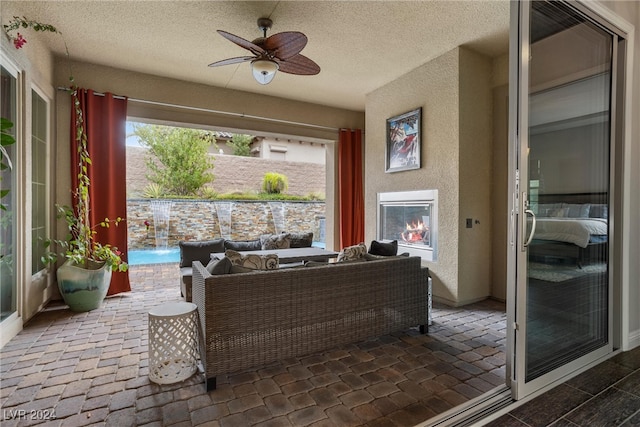 sunroom / solarium featuring ceiling fan