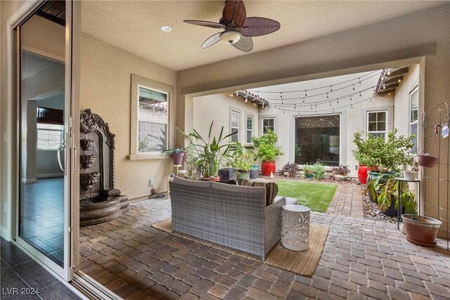 exterior space with ceiling fan and rail lighting