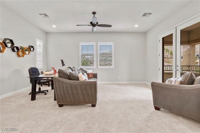 carpeted living room featuring french doors, a healthy amount of sunlight, and ceiling fan