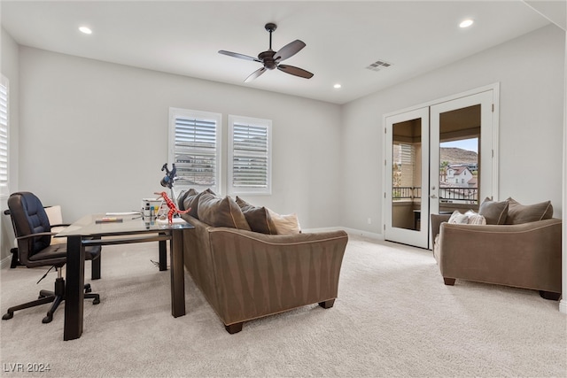 living room featuring light carpet, french doors, and ceiling fan