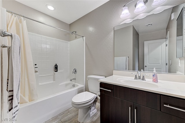 full bathroom with vanity, toilet, hardwood / wood-style flooring, and shower / tub combo