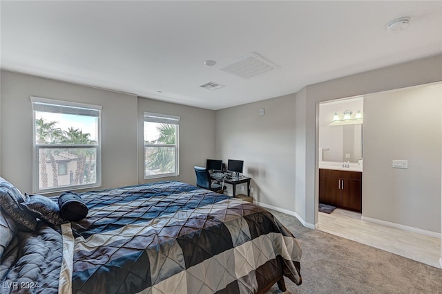 carpeted bedroom featuring ensuite bathroom