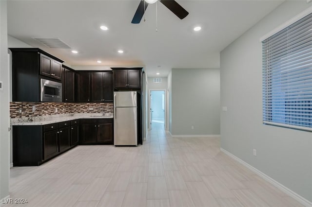 kitchen with ceiling fan, appliances with stainless steel finishes, dark brown cabinets, and tasteful backsplash