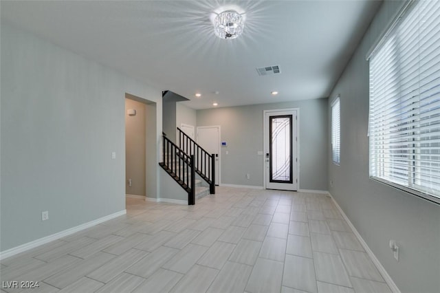 foyer entrance with a chandelier