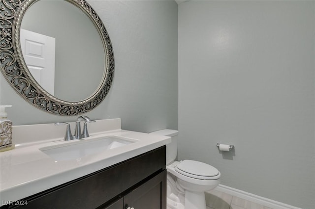 bathroom featuring toilet, vanity, and tile patterned flooring