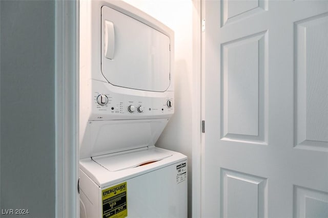 washroom with stacked washing maching and dryer