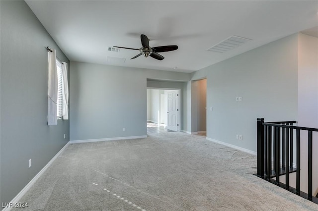 unfurnished room with ceiling fan and light colored carpet