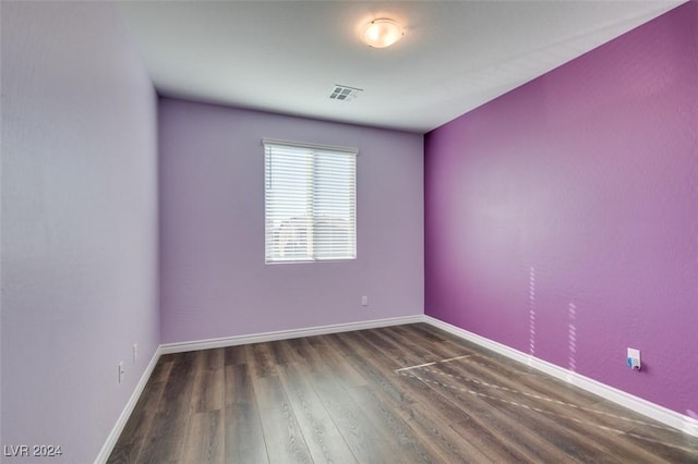 spare room with dark wood-type flooring