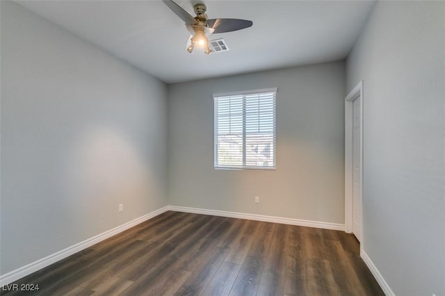 spare room with ceiling fan and dark hardwood / wood-style floors