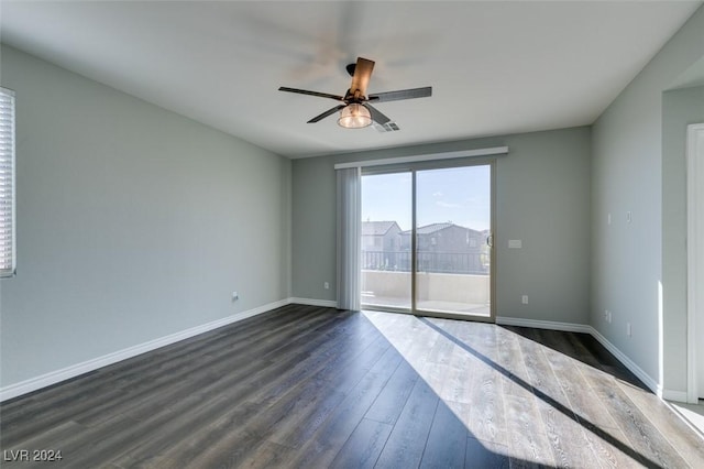 empty room with ceiling fan and dark hardwood / wood-style floors