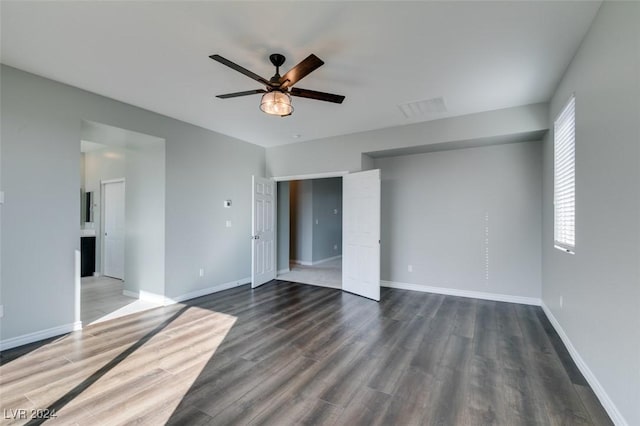 unfurnished bedroom with ceiling fan and dark hardwood / wood-style flooring