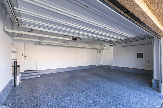 garage with electric panel and a garage door opener