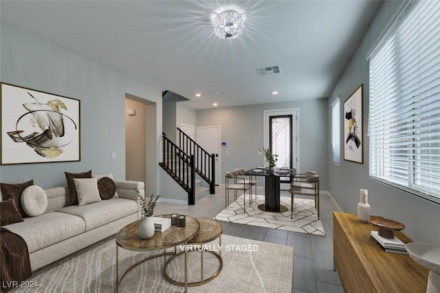 living room with an inviting chandelier and plenty of natural light