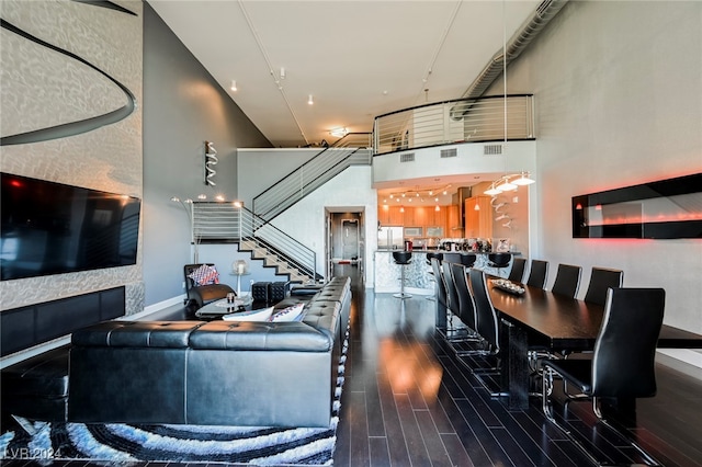 interior space with a high ceiling and dark hardwood / wood-style floors