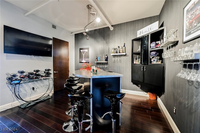 kitchen featuring a kitchen breakfast bar and dark hardwood / wood-style floors