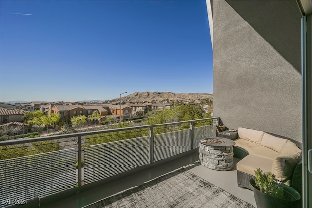 balcony featuring a mountain view and a fire pit