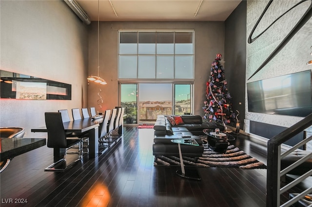 living room with a wall mounted air conditioner and dark hardwood / wood-style flooring