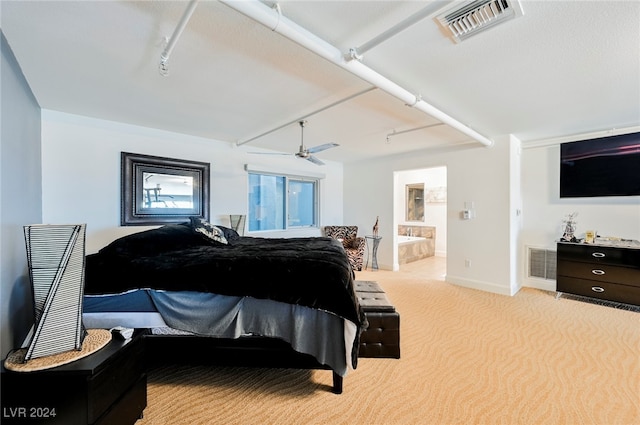 bedroom with light carpet, rail lighting, and ensuite bath