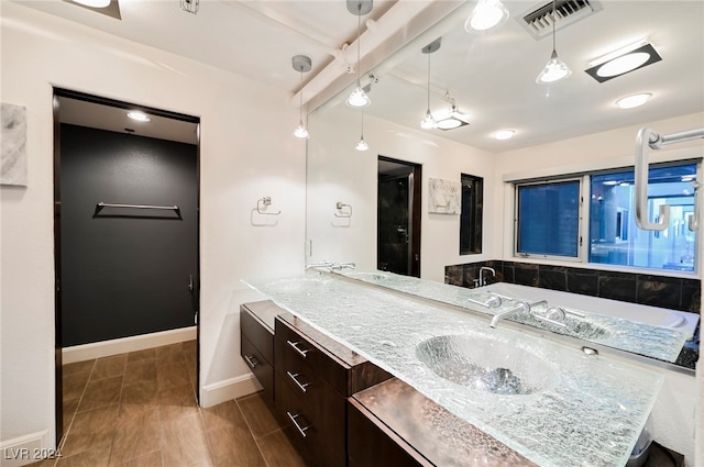 bathroom with vanity, beam ceiling, and hardwood / wood-style flooring