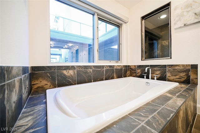 bathroom with tiled bath