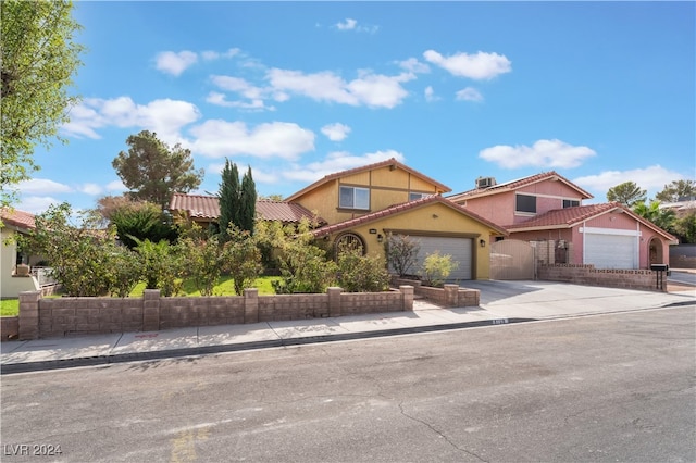 mediterranean / spanish-style house with a garage