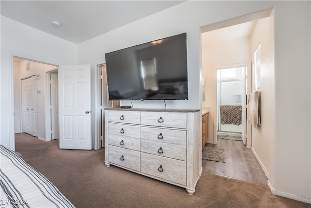 carpeted bedroom featuring ensuite bath