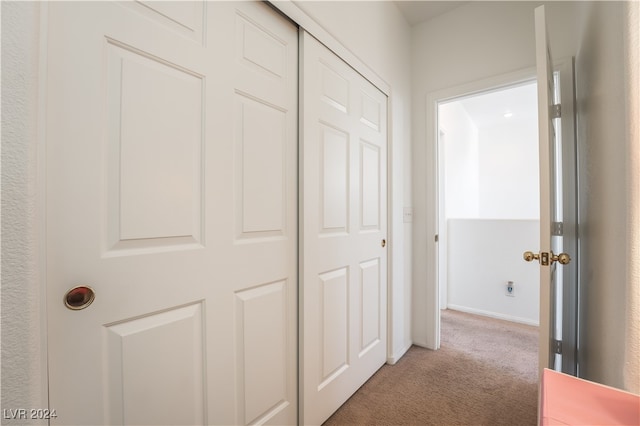 hall featuring carpet flooring