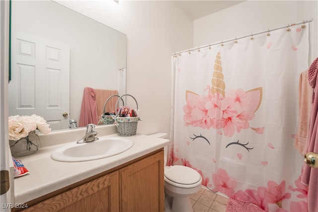 bathroom featuring vanity, toilet, and walk in shower