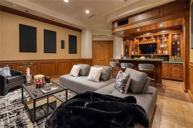 living room featuring light hardwood / wood-style floors and bar area