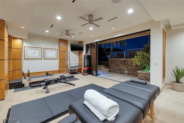 workout area with light colored carpet and ceiling fan