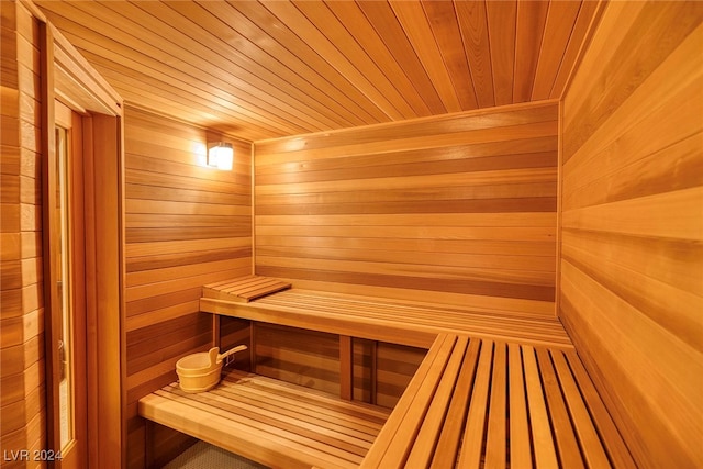 view of sauna featuring wooden walls and wood ceiling