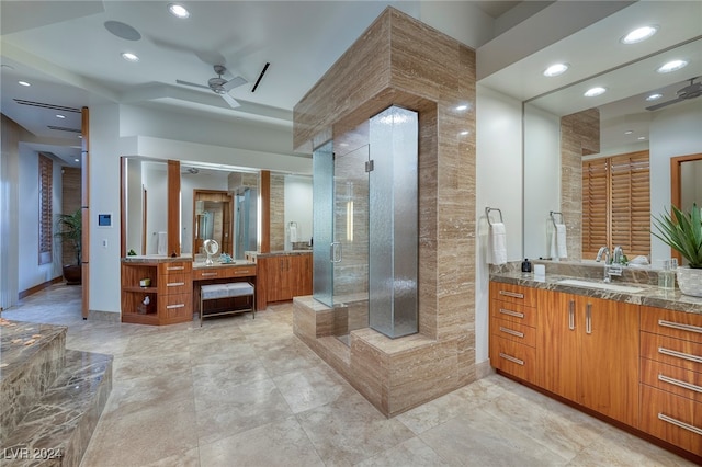 bathroom featuring vanity, a shower with shower door, and ceiling fan