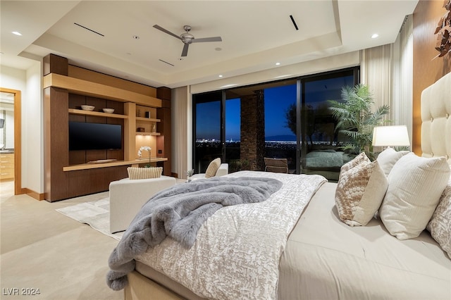 carpeted bedroom with access to exterior, a raised ceiling, and ceiling fan