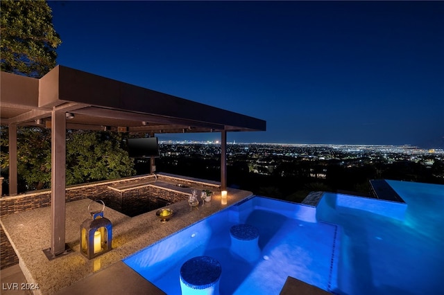 view of swimming pool with a hot tub