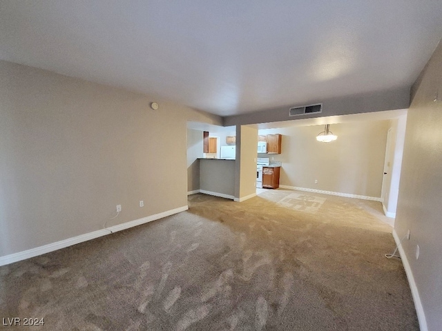 unfurnished living room with light carpet