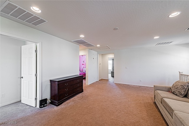 living room featuring light carpet and a textured ceiling