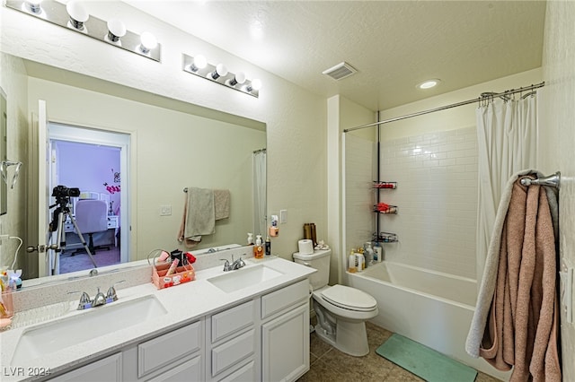 full bathroom featuring a textured ceiling, shower / bath combo, toilet, vanity, and tile patterned flooring