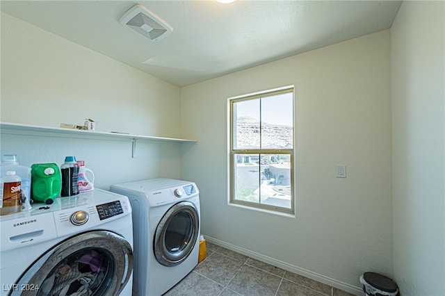 laundry room featuring light tile patterned floors and washing machine and clothes dryer