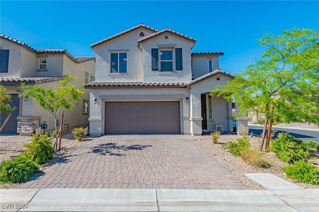 mediterranean / spanish-style home featuring a garage