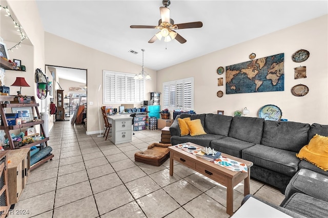 living room with ceiling fan, light tile patterned floors, and vaulted ceiling