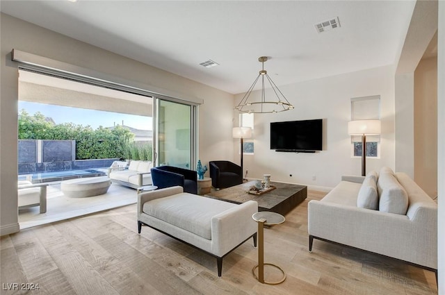 2567 Speyburn Ave, Henderson, NV 89044 - living room featuring light wood-type flooring and a chandelier