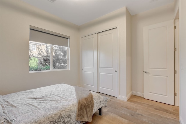 bedroom featuring a closet and light hardwood / wood-style floors