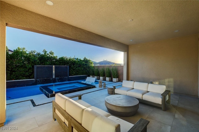 view of patio featuring a mountain view, a swimming pool with hot tub, and outdoor lounge area